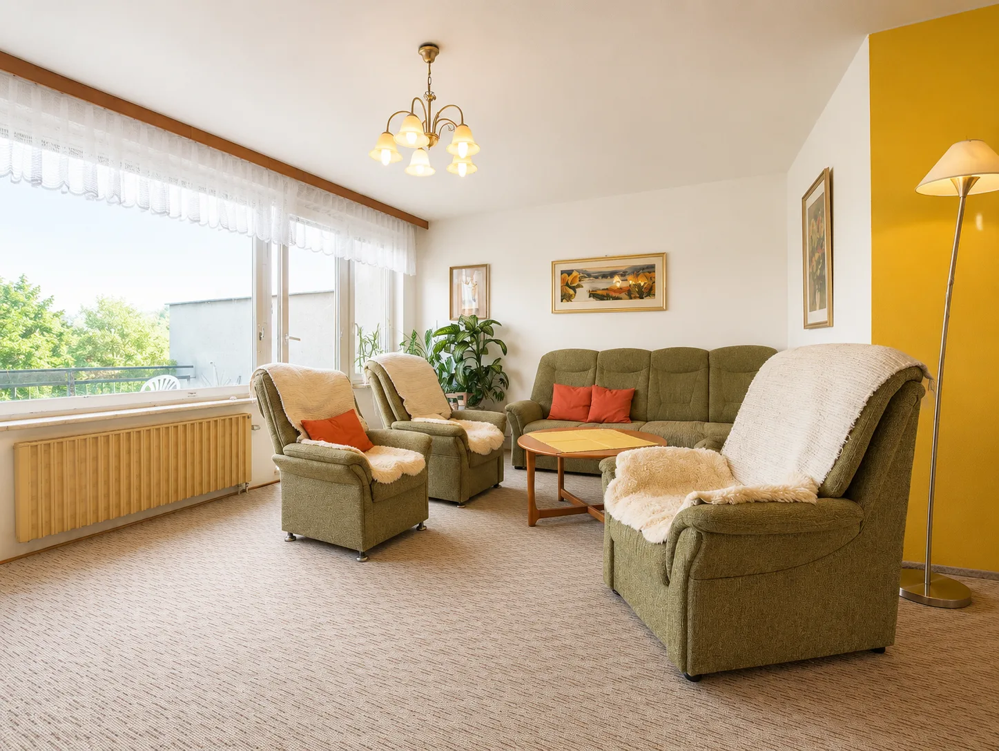 Living room with green seating set and large windows